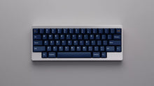 Load image into Gallery viewer, GMK CYL Blue Fabrik navy keycaps on dark keyboard, angled lifestyle photo on concrete surface