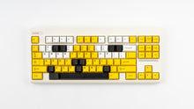 Load image into Gallery viewer, GMK CYL GREG 2 keycaps in the standard color layout on a cream Classic TKL keyboard, front view