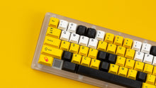 Load image into Gallery viewer, GMK CYL GREG 2 keycaps on a transparent 60 percent keyboard, left close-up with a red GREG novelty key