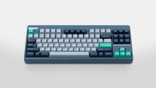 Load image into Gallery viewer, GMK CYL Hammerhead Small Batch keycaps on slate blue TKL keyboard with teal Enter and arrow accent keys, frontal top-down view