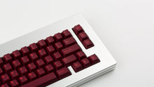 Load image into Gallery viewer, GMK CYL Infernal on a black silver keyboard zoomed in on right