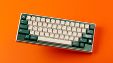 Load image into Gallery viewer, GMK CYL Kaiju R3 hiragana base keycaps top-down view on silver 65% keyboard, orange background