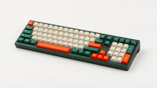 Load image into Gallery viewer, GMK CYL Kaiju R3 hiragana base keycaps on dark green full-size keyboard with numpad, angled view