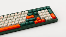 Load image into Gallery viewer, GMK CYL Kaiju R3 hiragana base keycaps close-up of right side and numpad on dark green keyboard