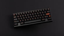 Load image into Gallery viewer, GMK CYL Kaiju R3 dark base keycaps on black 65% keyboard on dark background, top-down angled