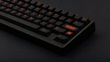 Load image into Gallery viewer, GMK CYL Kaiju R3 dark base keycaps close-up of right side on black 65% keyboard, dark background