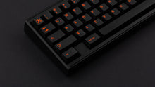 Load image into Gallery viewer, GMK CYL Kaiju R3 dark base keycaps close-up of left alphas on black 65% keyboard, dark background