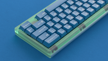 Load image into Gallery viewer, render of GMK CYL Masterpiece R2 keycaps on mint green acrylic Beetle 60 keyboard, close-up view