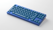 Load image into Gallery viewer, render of GMK CYL Masterpiece R2 keycaps on blue F1-8X keyboard, wide view