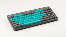 Load image into Gallery viewer, GMK CYL Hatsune Miku on a translucent grey CLASSIC-TKL angled