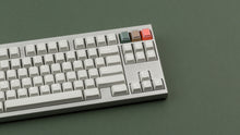 Load image into Gallery viewer, CYL Modern Materials concrete on a silver keyboard close up on right