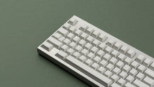 Load image into Gallery viewer, CYL Modern Materials concrete on a silver keyboard close up on left