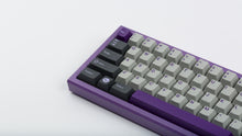Load image into Gallery viewer, GMK CYK NTD on purple keyboard zoomed in on left