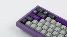 Load image into Gallery viewer, GMK CYK NTD on purple keyboard super close shot on right side