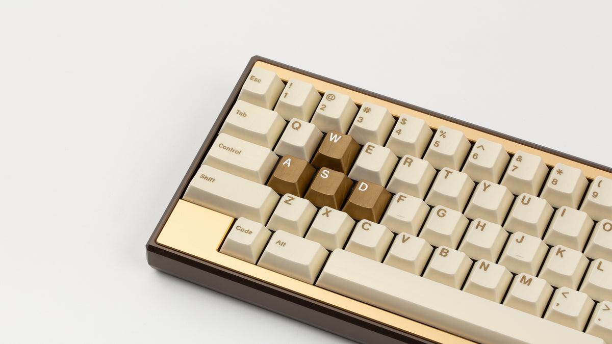 GMK CYL Rainbow 6 Siege - Winner's Circle on a Dark Gold Keycult Zero with Gold HHKB accent bars close up on left side angled 