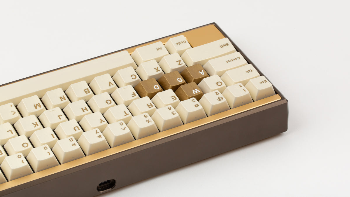  GMK CYL Rainbow 6 Siege - Winner's Circle on a Dark Gold Keycult Zero with Gold HHKB accent bars back view close up on left side angled 