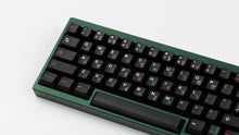 Load image into Gallery viewer, GMK CYL Tribal on a green keyboard close up on left side angled