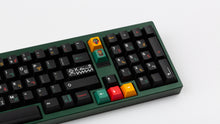 Load image into Gallery viewer, GMK CYL Tribal on a green keyboard close up on right side angled