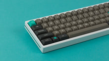 Load image into Gallery viewer, MTNU Dolch on a White Keyboard close up left side