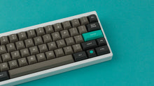 Load image into Gallery viewer, MTNU Dolch on a White Keyboard close up right side