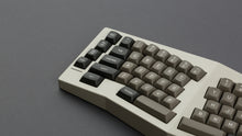 Load image into Gallery viewer, MTNU Dolch on a Beige Type K Keyboard close up on left side