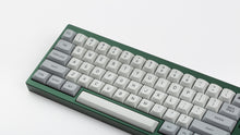 Load image into Gallery viewer, MTNU Granite on a green keyboard close up on left side