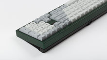 Load image into Gallery viewer, MTNU Granite on a green keyboard back view angled close up on right side