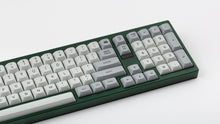 Load image into Gallery viewer, MTNU Granite on a green keyboard close up on right side