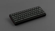 Load image into Gallery viewer, MTNU Graphite on a black and red keyboard