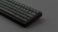 Load image into Gallery viewer, MTNU Graphite on a black and red keyboard close up on right