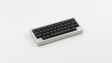 Load image into Gallery viewer, MTNU Graphite on a silver keyboard