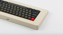 Load image into Gallery viewer, MTNU Susu on a beige keyboard back view left side