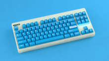 Load image into Gallery viewer, render of Unobtanium Blue on a CLASSIC GLO keyboard angled on a blue background