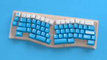 Load image into Gallery viewer, render of Unobtanium Blue on a Rikia keyboard on a blue background
