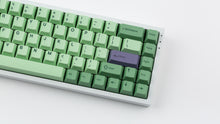 Load image into Gallery viewer, GMK CYL Zooted keycaps on silver 65% keyboard, close-up of right side highlighting the purple Enter accent key, navigation column, and arrow cluster on white surface