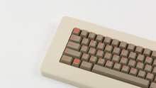 Load image into Gallery viewer, Key Kobo Signet on a beige keyboard zoomed in on left