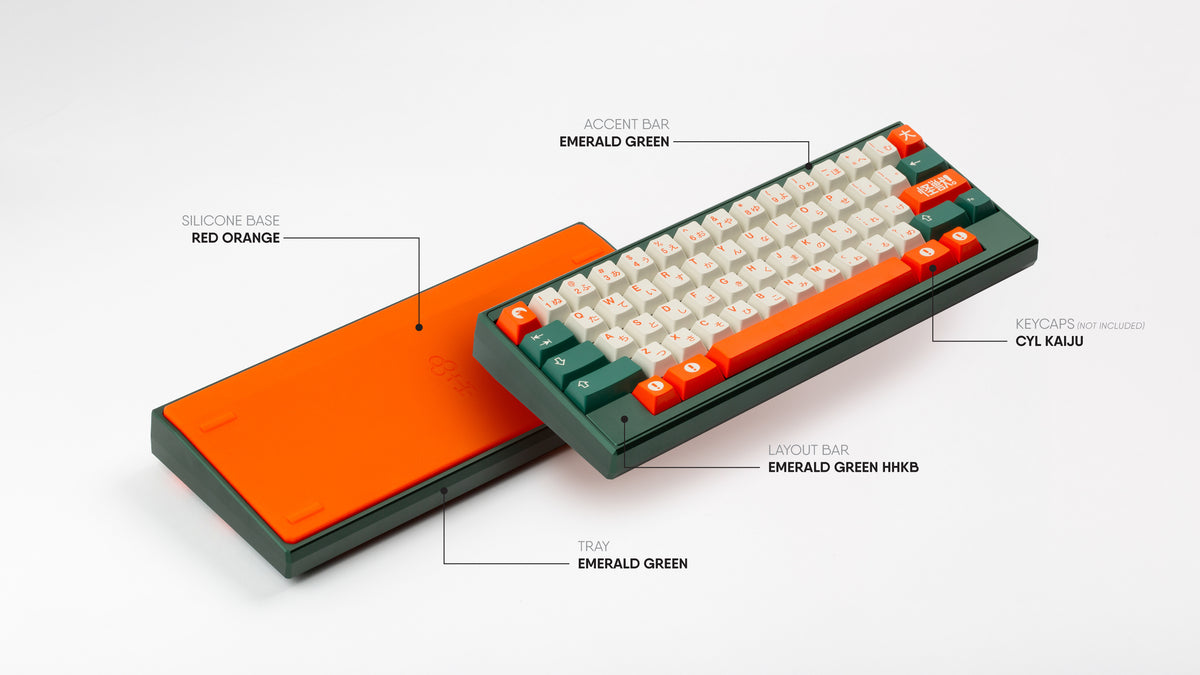 GMK CYL Kaiju on a Keycult ZERO with a silicone orange bottom, emerald green top, and emerald green straight and HHKB accent layout bars