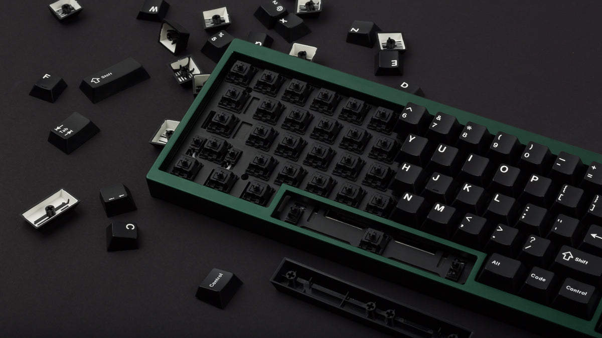green case featuring white on black keycaps and black switches