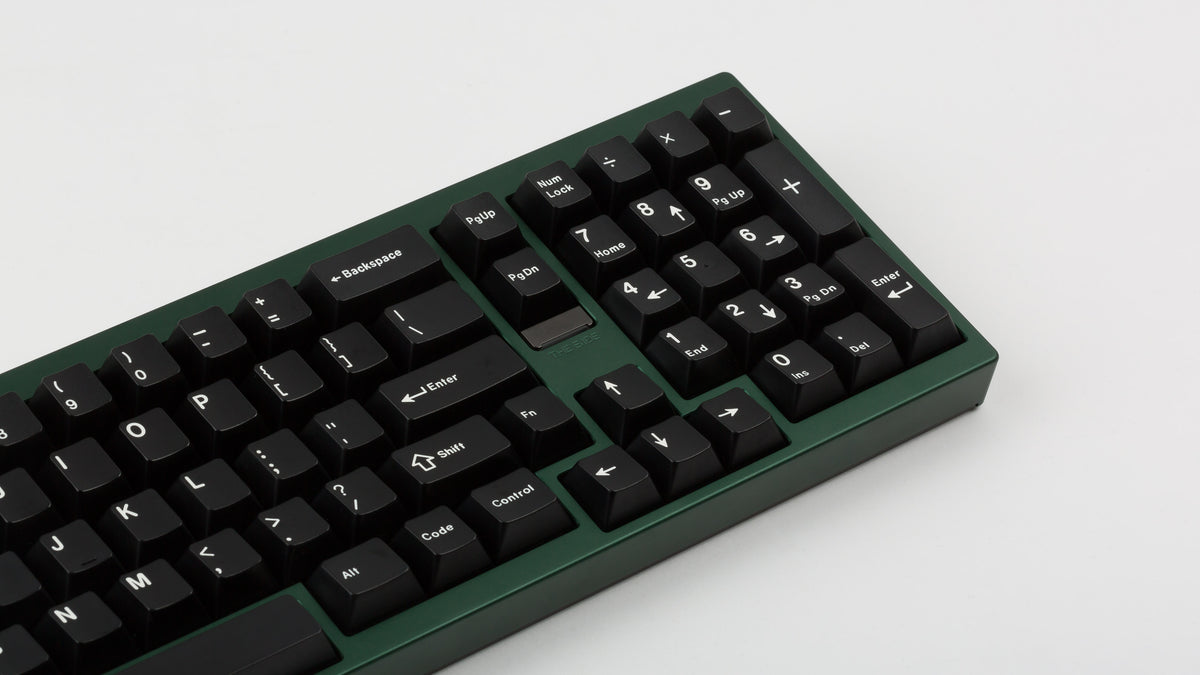 green case featuring white on black keycaps zoomed in on right