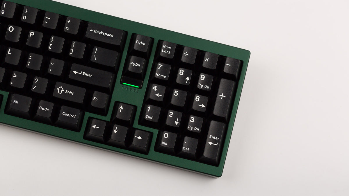 green case featuring white on black keycaps angled right side