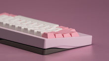 Load image into Gallery viewer, Close-up of a keyboard with pink and white keys on a purple background