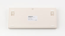 Load image into Gallery viewer, Back of Smurve80 keyboard in Sandstone showing adjustable feet and product label