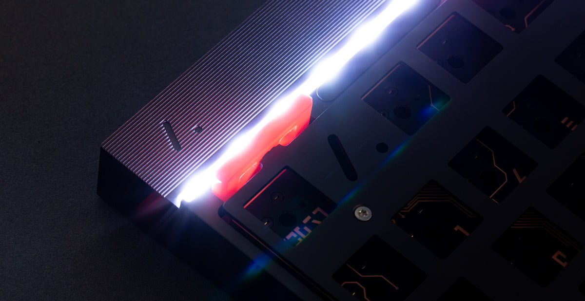 Artifact Stratum 80 light guide LED strip glowing white with lens flare along the top edge