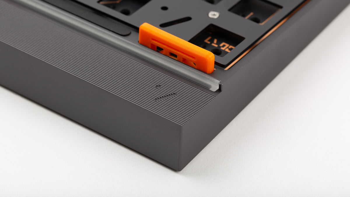 Artifact Stratum 80 rear detail showing ribbed weight, USB-C port, and orange flexbrick gasket