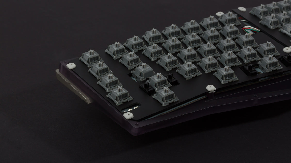 Anodized black Type-K with plate and weight zoomed in on left featuring dark gray switches