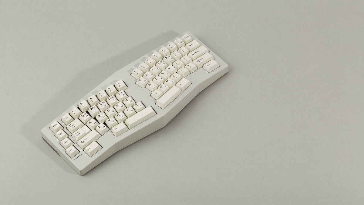 Powder coat beige Type-K angled view with sandblasted stainless steel weight featuring black on beige keycaps