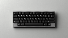 Load image into Gallery viewer, render of GMK Mono top down on a silver carbon fiber keyboard