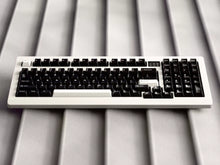 Load image into Gallery viewer, Render of GMK CYL WoB black keycaps with red accents on silver keyboard, front angled view