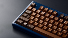 Load image into Gallery viewer, Render of GMK CYL Chocolatier keycaps on a keyboard, detailed view of the keycap legends and colorways