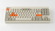 Load image into Gallery viewer, Render of GMK CYL Mini Orange Accent Pack keycaps on beige Classic TKL keyboard, full top-down view